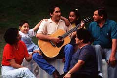 Man Playing Guitar with Family